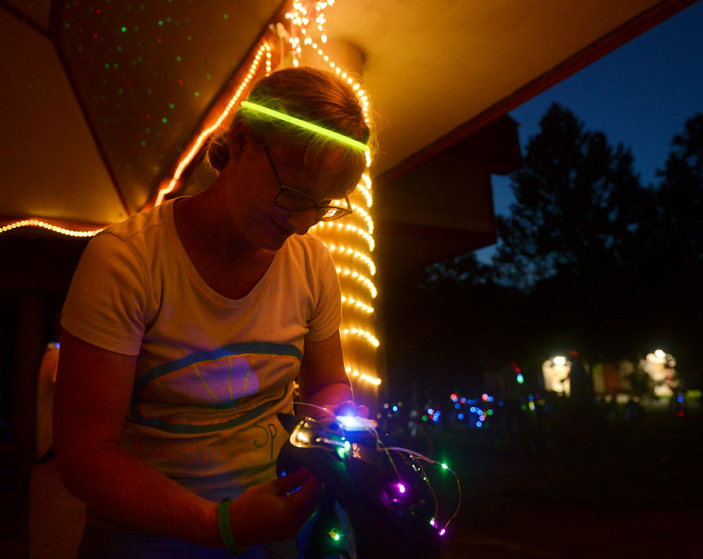 Wendy Gruber attaches lights to her bike helmet before heading back